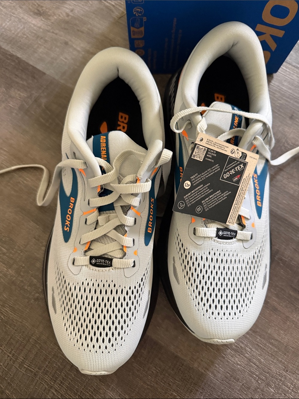 NIB. Brooks Mens Light Gray Sneakers with Blue and Orange Accents